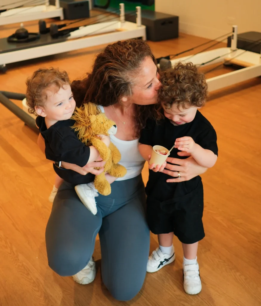 Pilates Instructor Posing with Her Kids